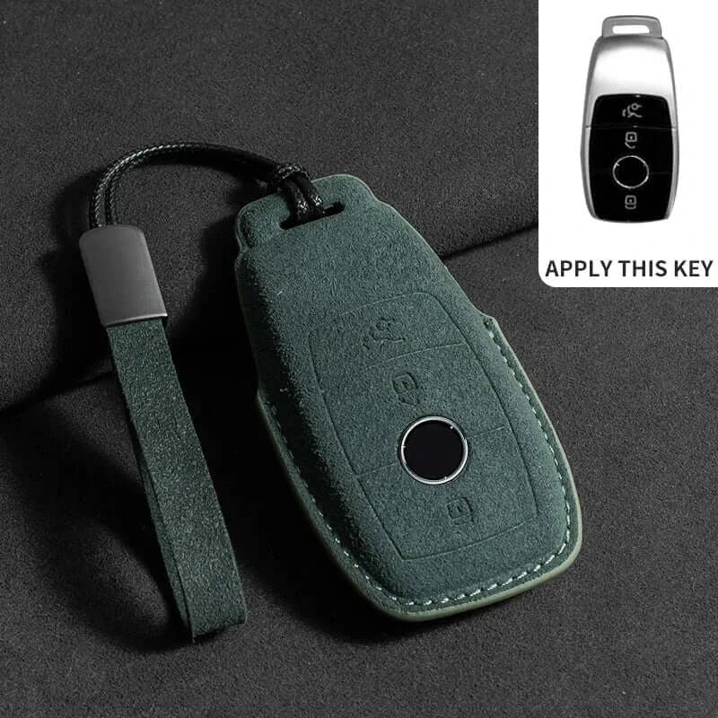 Suede leather key fob case Mercedes Benz in green color displayed on a black surface.