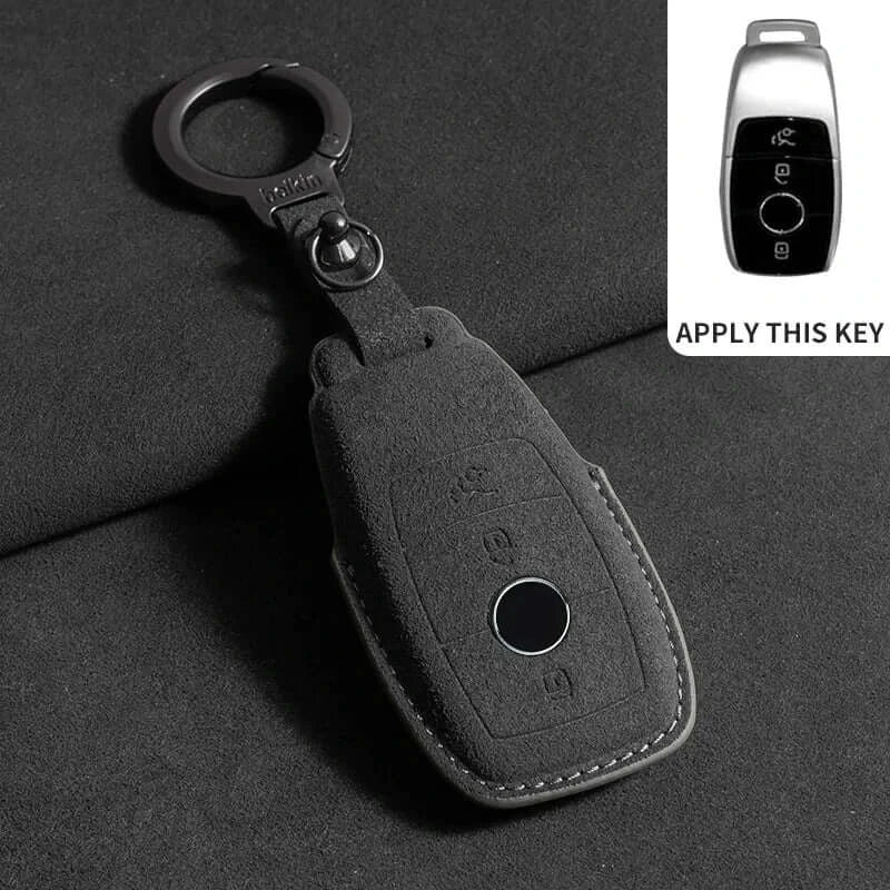 Suede leather key fob case Mercedes Benz in black with keychain on a dark background.